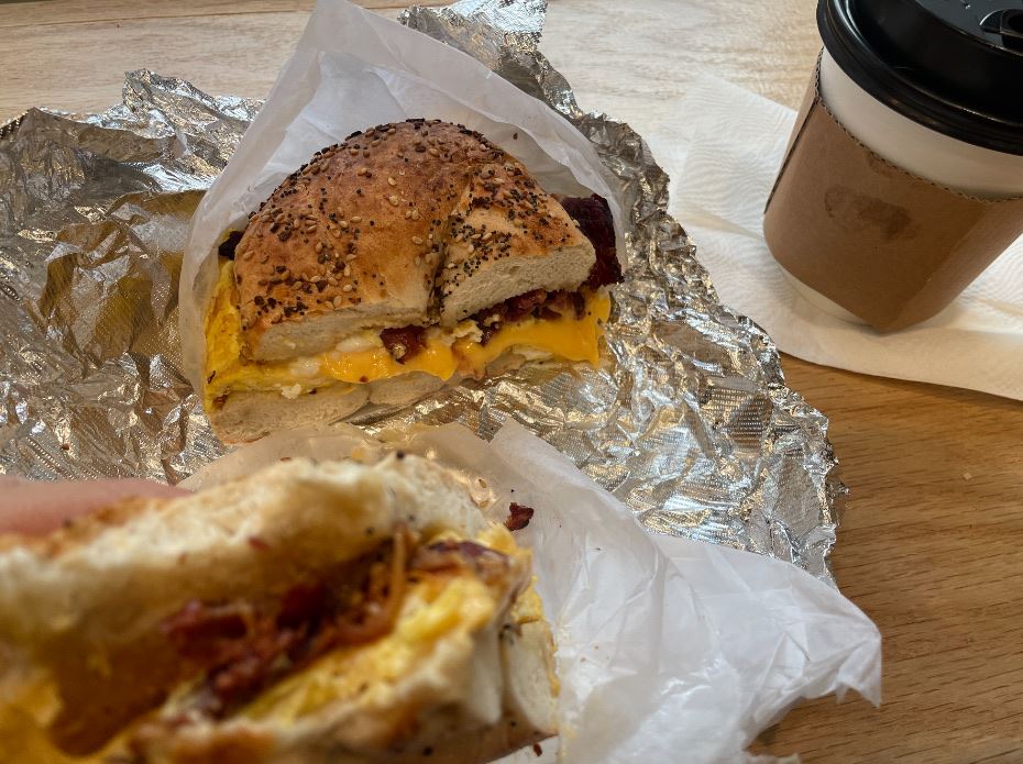 Bacon egg and cheese on an everything bagel with a coffee from Krave