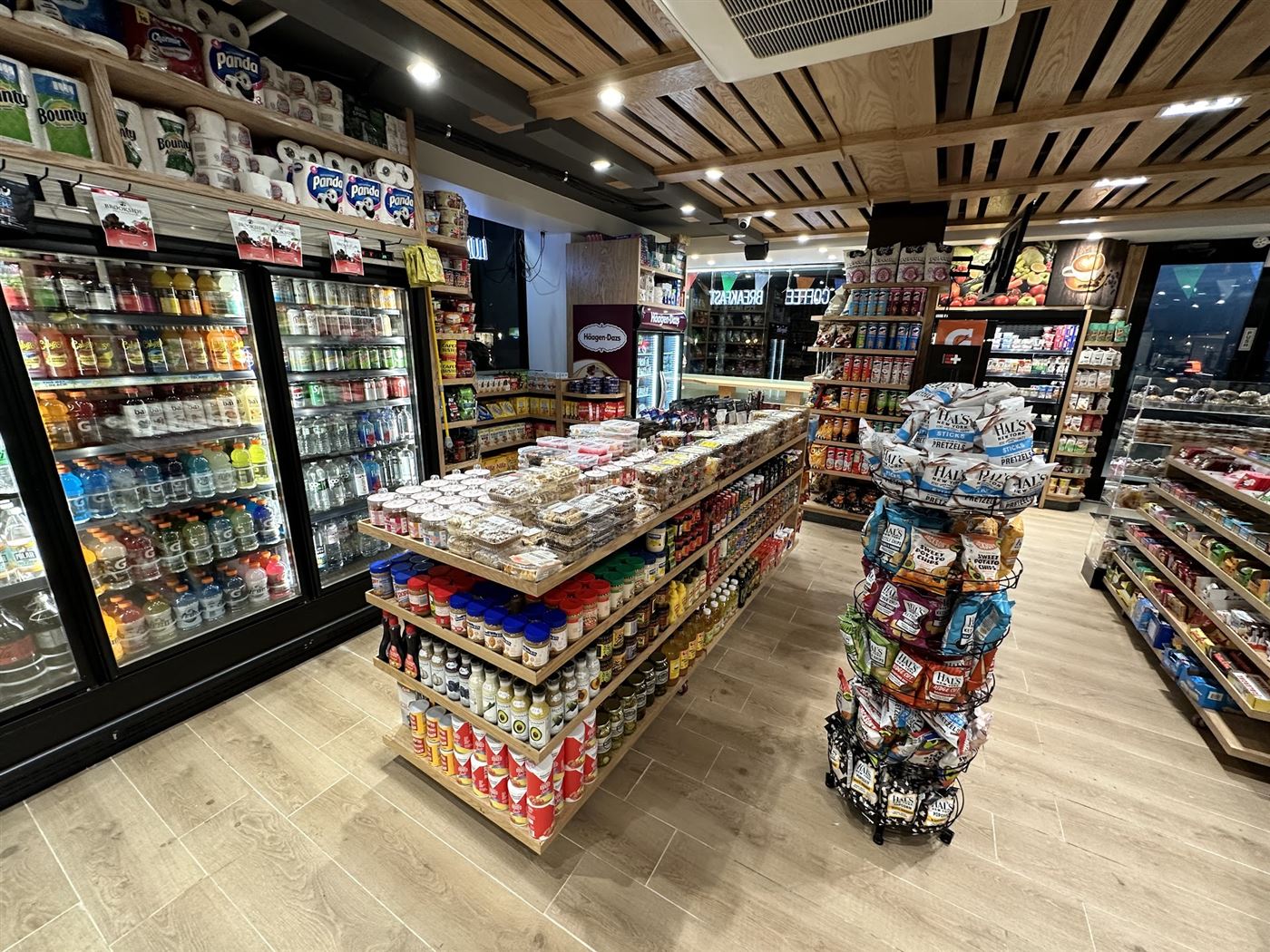 Inside Krave Deli &mdash; wood-slat ceilings, stocked shelves, and the fresh bakery table